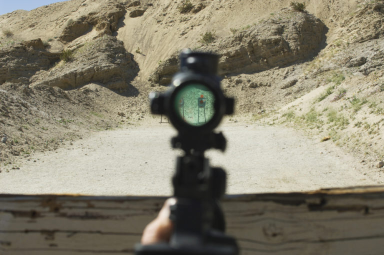 Rifle sight aiming at target on firing range